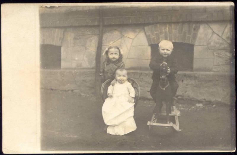 Baby and Two Young Children with Rocking Horse (1910s) RPPC