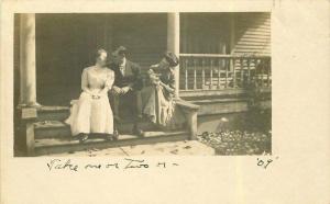 C-1910 Couple sitting woman holding kewpie doll RPPC Photo Postcard 5457
