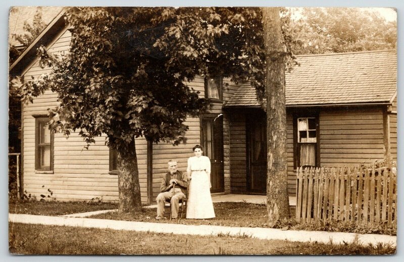 Beaverville IL Dufrain~Older Couple Front of Simple House~Picket Fence~1912 RPPC 