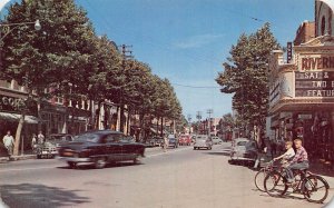 RIVERHEAD LONG ISLAND NY-MAIN STREET-THEATER-BOYS ON BICYCLE 1940-50s POSTCARD