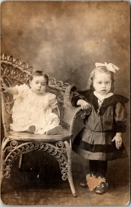 RPPC Real Photo Postcard Little Girl and Toddler Sitting in a Chair C.1910 K12
