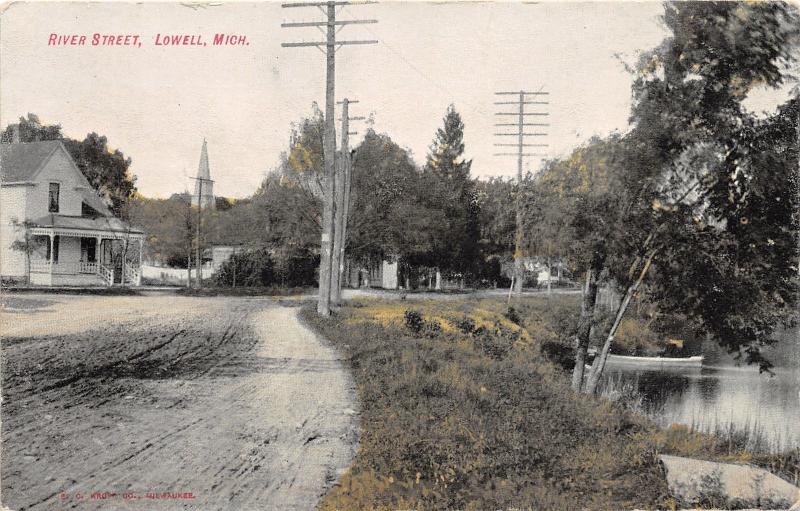 Lowell Michigan~River Street~House~Church Steeple~Boat on River~c1910 Postcard