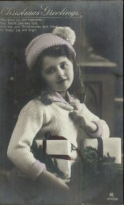 Christmas - Pretty Little Girl Hat Holding Presents Tinted Real Photo Postcard