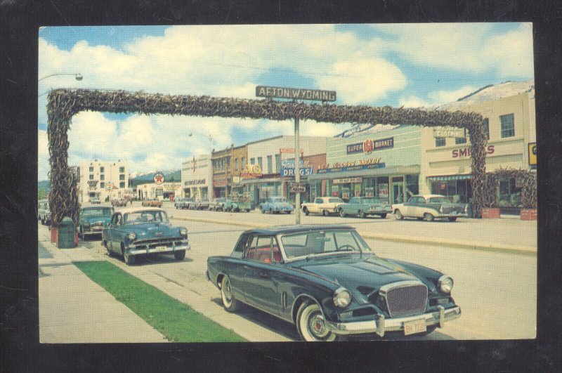 AFTON WYOMING DOWNTOWN ELK HORN ARCH OLD CARS STUDEBAKER HAWK VINTAGE POSTCARD