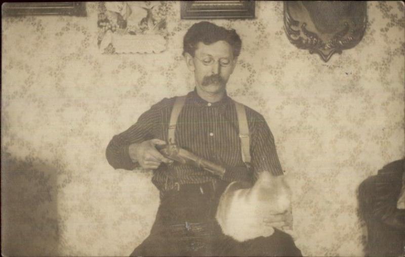 Unusual Bizarre Man Eyeglasses Moustache Gun at Cat's Head Real Photo Postcard