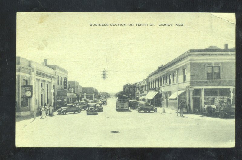 SIDNEY NEBRASKA DOWNTOWN STREET SCENE OLD CARS STORES VINTAGE POSTCARD