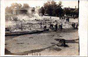 RPPC: People around burned out remains of building that was on fire