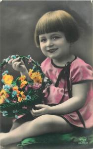 Vintage tinted cute children postcard smile girl flowers bascket