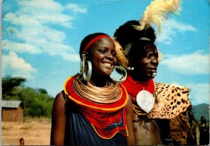 VINTAGE CONTINENTAL SIZE POSTCARD TURKANA WARRIOR AND WOMAN IN TURKANA KENYA