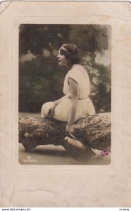 Girl sitting on a log , 00-10s