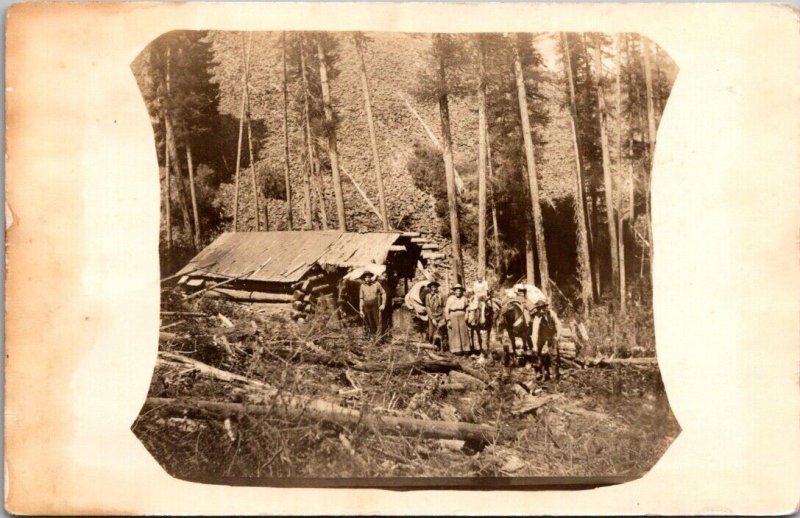 Real Photo Postcard Men and Women at a Log Cabin in Woods, Pack Horses 