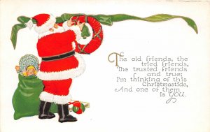 F95/ Santa Claus Merry Christmas Postcard c1910 Toys Hang Wreath 24