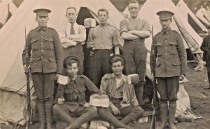 BRITISH SOLDIERS IN FRONT OF TENT HOLDING LOAVES OF BREAD?~REAL PHOTO POSTCARD