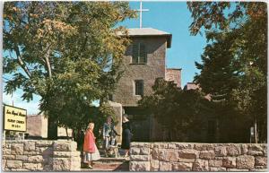 San Miguel Mission - exterior front view with women and child