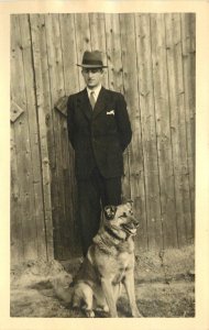 RPPC Alsatian or German Shepherd Dog with Man in Suit & Hat, Europe 1930s