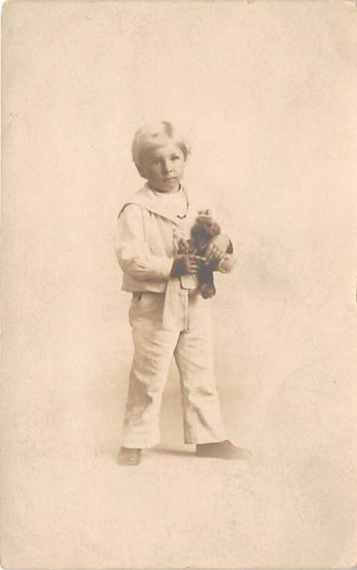 Young boy with toy Child, People Photo Writing on back 