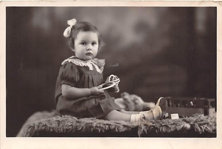 Little girl with toys Child, People Photo Writing on back 