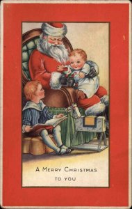 Christmas Santa Claus With Baby on Lap in Chair c1915 Whitney Postcard