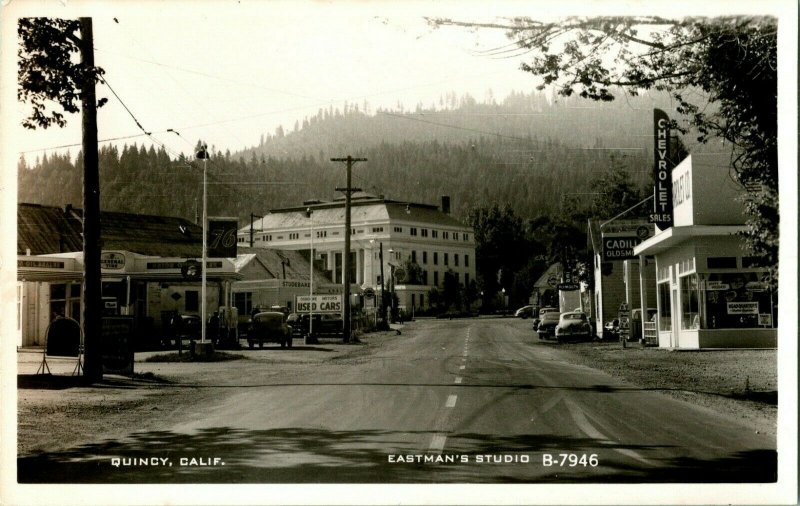 Vtg Postcard RPPC Quincy CA Eastman's Studio B-7946 Street View Chevy 76 Signs