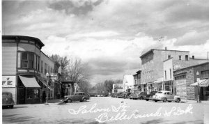 Vtg Saloon Street View Belle Fourche SD Cars Coca Cola Texaco RPPC 1940 Postcard