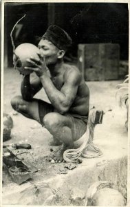 indonesia, SUMATRA, Native Batak Man drinking from Fruit (1920s) RPPC Postcard