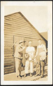 Three Working Men in Front of Wooden Building RPPC Unused c1910s