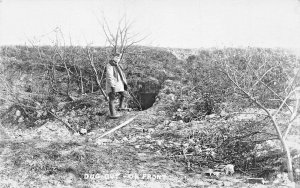 WW1 MILITARY SOLDIER~DUG OUT BUNKER ON FRONT~REAL PHOTO POSTCARD