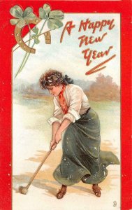 WOMAN PLAYING GOLF HAPPY NEW YEAR HOLIDAY EMBOSSED POSTCARD (c. 1909)