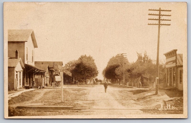 Letts IN Man Walks on Dirt Main St~Shops~Railroad Crossing~Horse & Buggy~RPPC