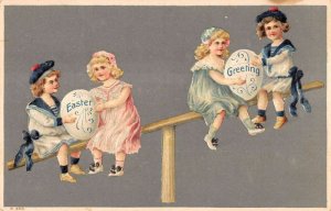 Easter Greeting young children on seesaws holding eggs antique pc BB1619