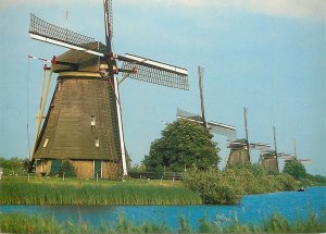 Postcard Netherlands ( WIND MILL ) mill setup on waterfront rowboat