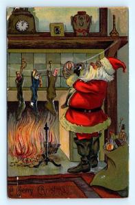 Postcard Merry Christmas Night Before Santa Putting Toys in Stockings H20