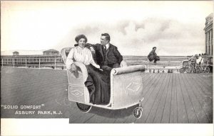 Solid Comfort, Couple In Rolling Boardwalk Chair Asbury Park NJ Postcard P76