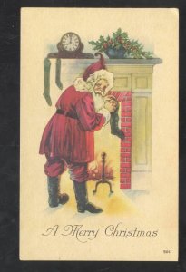 A MERRY CHRISTMAS CLODK SANTA CLAUS FULL RED ROBE VINTAGE POSTCARD XMAS