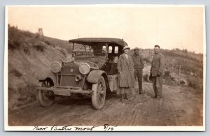 Butte MT~Muddy Car on Road~Lady & Gents~Des Moines Pennant in Window~1915 RPPC