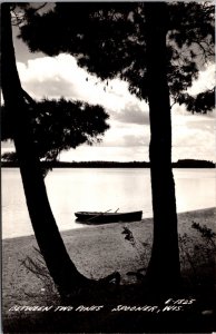 Real Photo Postcard Between Two Pines Boat on Lake in Spooner, Wisconsin