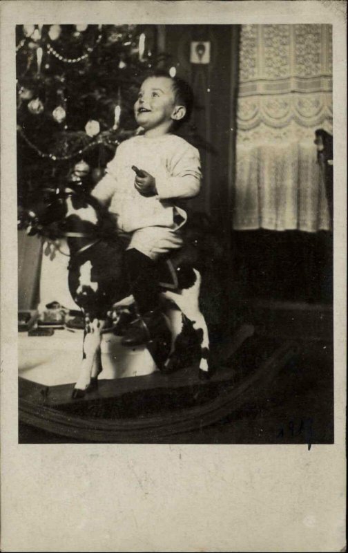 Christmas Happy Boy Riding Horse Toy Decorated Tree c1910 Real Photo Postcard