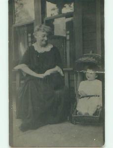 Pre-1920's rppc CHILD IN UNUSUAL COVERED WICKER CHAIR WITH HANDLE ON TOP r6340