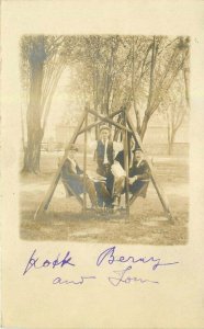 C-1910 Well Dressed Men with hats sitting in Swing RPPC Photo Postcard 21-10247