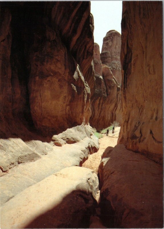 Postcard Arches National Park - Hikers in the Fiery Furnace