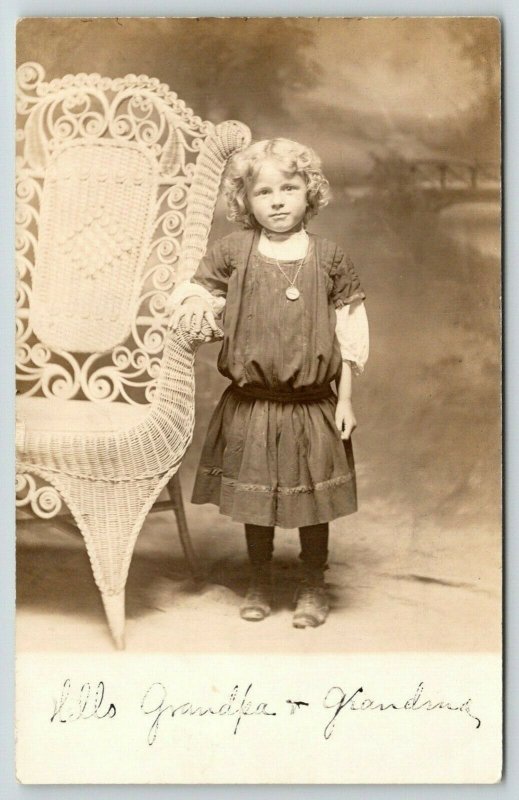 RPPC Hello Grandpa & GrandmaCute Girl w/Wicker Chair Bigger Than She Is1910