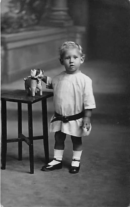 Little child with toy Child, People Photo Writing on back 