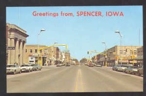 GREETINGS FROM SPENCER IOWA DOWNTOWN STREET SCENE OLD CARS POSTCARD