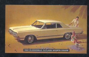 1965 OLDSMOBILE CUTLASS SPORTS COUPE CAR DEALER ADVERTISING POSTCARD OLDS