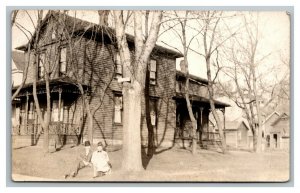 Vintage 1910's RPPC Postcard - Man and Wife Lounge in Front Large Suburban Home