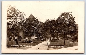 Cedar Rapids IA Lady Walks Thru George Greene Square Park w/Parasol~RPPC 1909 pc