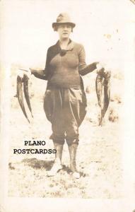 WOMAN WITH THE CATCH OF THE DAY-1920'S ERA RPPC REAL PHOTO POSTCARD