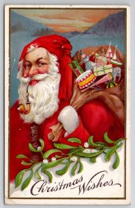 Christmas Wishes Santa with Toy Sack Pipe Mistletoe Mountain Sunset Postcard J22