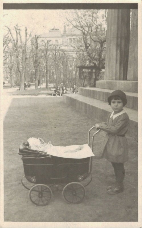 Little Girl playing with a doll pram  RPPC 03.66