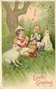 c1910 BW Embossed Easter Postcard Kids Eating Eggs in Forest with White Rabbits